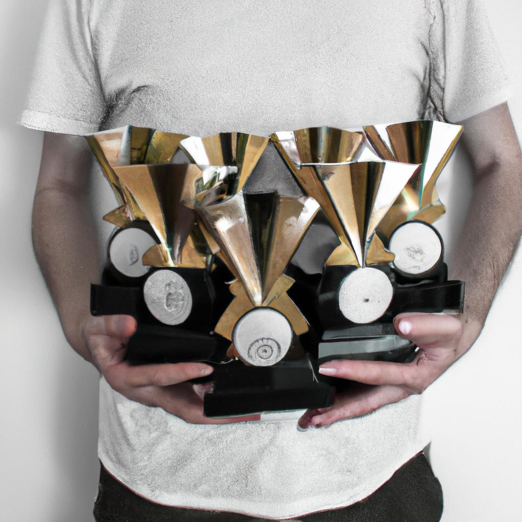 Person holding multiple music awards